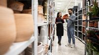 Saleswoman Assisting Man in Choosing Decorative Flower Pots
