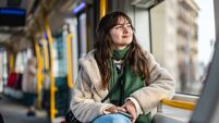 Young woman looking out of the tram window