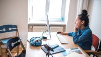 teenage girl sitting in front of computer at desk