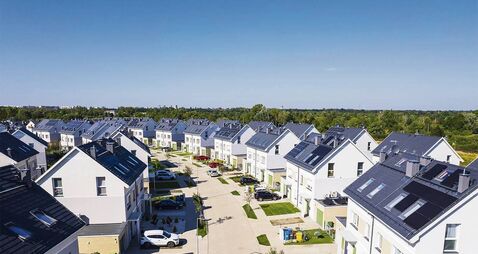 aerial view of solar panels on city or rural residential homes and neighborhoods