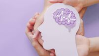 Adult and child hands holding encephalography brain paper cutout,autism, Stroke, Epilepsy and alzheimer awareness, seizure disor