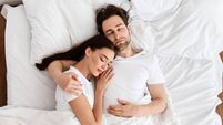 Married Couple Sleeping Embracing In Comfortable Bed Indoor, Top View