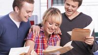 Student teenagers opening good exam results