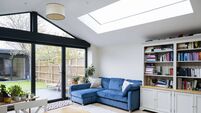 Interior of living area of modern home extension with skylight and large patio doors