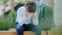 Tired Schoolboy Sitting Alone on a Bench After a Long, Stressful School Day
