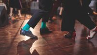 Dancing shoes of young couple dance retro jazz swing dances on a ballroom club wooden floor, close up view of shoes, female and