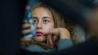 Young girl relax with her smartphone on a sofa