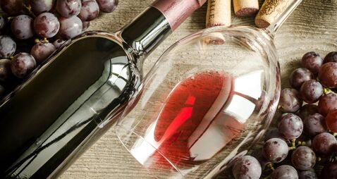 Still life photo of grapes, wine bottle and wine glass