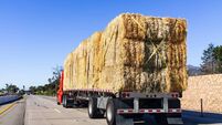 Truck transporting bales of hay on a freeway in Ventura County, South California
