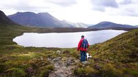 Man walking in the Mourne mountains in Northern Ireland - Stock photo