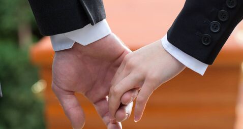 People at funeral consoling each other