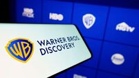 Stuttgart, Germany, 09-22-2022: Mobile phone with logo of media company Warner Bros. Discovery Inc. (WBD) on screen in front of